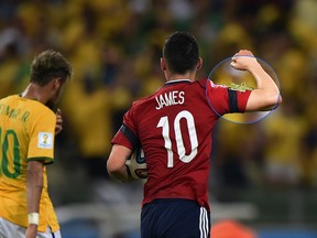 Colombia's James Rodriguez scored a goal and made a friend against Brazil in Fortaleza on Friday. (FABRICE COFFRINI/AFP)