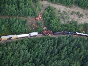 CN work crews clean up after a eastbound freight train derailed west of Whitecourt, Alta. on July 4, 2014. (Jonas Boll photo/Special to QMI Agency)