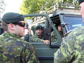 The first batch of soldiers from CFB Shilo arrive at the Portage la Prairie Armory  on Fri., July 4, 2014. The province has called in the Canadian Forces to assist with its flood fight after declaring a state of emergency. (Kevin King/ Winnipeg Sun/QMI Agency)