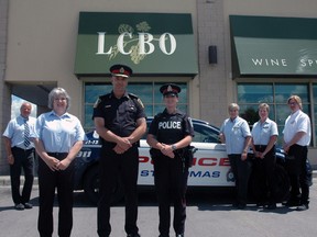 St. Thomas LCBO assistant manager Janet Traichevich, foreground left, St. Thomas Police Chief Darryl Pinnell and Const. Leanne Evans stand with a group of other LCBO employees. The St. Thomas store has been recognized as one of the best in Ontario at reporting suspected drunk drivers. (Ben Forrest, Times-Journal)