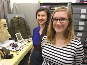 Museum of Health Care communications co-ordinator Diana Gore, left, and manager Jenny Stepa stand in front of some of the museum's First World War artifacts. A new summer program marking the 100th anniversary of the start of the war will begin later this month. (Michael Lea/The Whig-Standard)