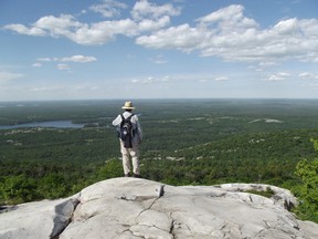 Jim Moodie/The Sudbury Star
Raymond Soffer of Ottawa surveys the view to the north, over David Lake, from a lookout en route to Silver Peak. Soffer and daughter Jamie, a student at Laurentian University, were visiting the famous hill as part of a canoe trip departing from Johnny Lake and looping through Bell Lake, via Log Boom Lake.