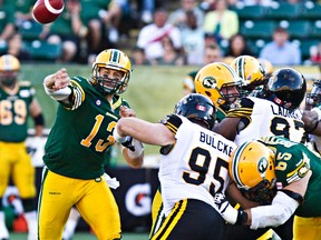 Mike Reilly throws during the first quarter of Friday's game against the Hamilton Tiger-Cats at Commonwealth Stadium. (Codie McLachlan, Edmonton Sun)