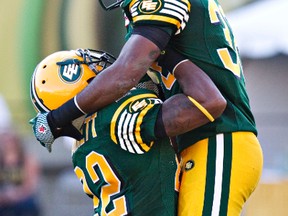 Edmonton’s Joe Burnett and Eric Samuels, No. 38, celebrate a sack on Hamilton’s Zach Collaros Friday at Commonwealth Stadium. (Codie McLachlan, Edmonton Sun)