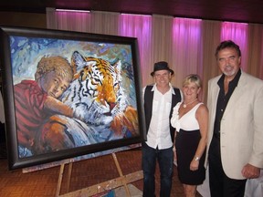 Leo Van Lier (right) and wife Debra, proud owners of a new Louis Lavoie masterpiece created last weekend in support of Al Shamal Shriners