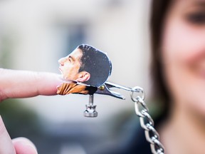 This handout picture made available by Swedish online sex toy shop "Oliver & Eva" shows a woman demonstrating a nipple clamp depicting Uruguay's forward Luis Suarez on July 1, 2014 in Stockholm. (AFP PHOTO / HO/Oliver & Eva/TOBIAS LUNDQVIST)