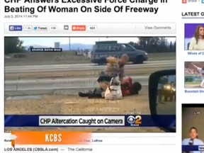 An officer appears to be pummelling a woman alongside a Los Angeles freeway in this Newsy video screengrab.
