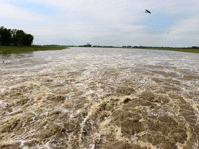 Water from the Assiniboine River rushes through the Portage Diversion in Portage la Prairie, Manitoba, on July 4, 2014. The structure reroutes a portion of the river's water to Lake Manitoba. (Kevin KingQMI Agency)