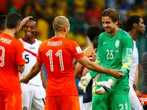 Costa Rica's Celso Borges congratulates Robin van Persie (9), Arjen Robben and Goalkeeper Tim Krul of the Netherlands after the penalty shootout in their 2014 World Cup quarter-finals at the Fonte Nova arena in Salvador July 5, 2014. (REUTERS/Paul Hanna)