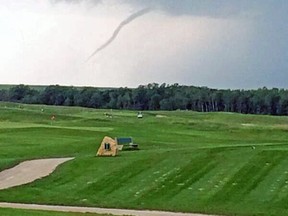 A pair of funnel clouds, including this one spotted near Southwood Golf & Country Club on Saturday, July 5, 2014 prompted tornado warnings from Environment Canada but dissipated without touching down. (Trish Jordan /twitter.com/aggiecoolchick)