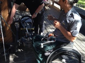 Banff-Cochrane MLA Ron Casey talks with Alberta Parks employee Christian Bagg, who explains to the Park Explorer wheelchair, aimed to help disabled people navigate rough terrain. Supplied photo