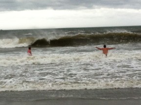 Some brave people embraced the waves caused by post-tropical storm Arthur, taking a dip at Rissers Beach on Nova Scotia's south shore on July 5, 2014. (Kris Sims/QMI Agency)