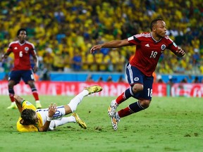 Brazil's Neymar (L) falls after being fouled by Colombia's Camilo Zuniga during their 2014 World Cup quarter-finals at the Castelao arena in Fortaleza July 4, 2014. (REUTERS/Marcelo Del Pozo)