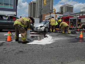Firefighters cut the driver from a car after a three-vehicle crash at Wellington and York streets Sunday around 2 p.m. The driver suffered non-life threatening injuries. DALE CARRUTHERS / THE LONDON FREE PRESS