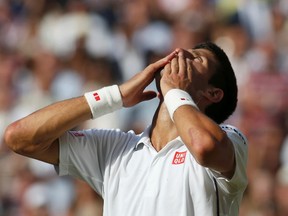 Novak Djokovic of Serbia celebrates defeating Roger Federer of Switzerland in their men's singles final tennis match at the Wimbledon Tennis Championships, in London July 6, 2014.               REUTERS/Sang Tan/Pool