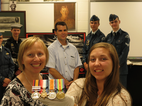 Waterdown District High School museum curator Elizabeth Longley holds "In Flanders Fields" author John McCrae's medals, with Guelph city head museum curator Bev Dietrich, left, and teacher Rob Flosman plus cadets. (IAN ROBERTSON/Toronto Sun)