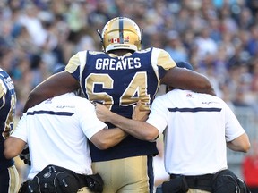 Winnipeg Blue Bombers OL Chris Greaves leaves the field during CFL action against the Ottawa RedBlacks at Investors Group Field in Winnipeg, Man., on Thu., July 3, 2014. Kevin King/Winnipeg Sun/QMI Agency