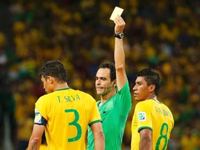 Brazil's Thiago Silva is shown the yellow card during the World Cup quarterfinals against Colombia at the Castelao arena in Fortaleza, Brazil on Friday, July 4, 2014. (Yves Herman/Reuters)