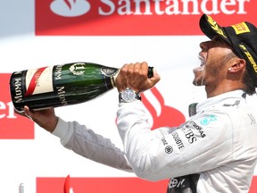Formula One driver Lewis Hamilton of Britain celebrates after winning the British Grand Prix at Silverstone Race Circuit in central England Sunday. (Francois Lenoir/Reuters)