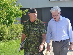 Premier Greg Selinger chats with Maj.Gen Michael Lagace at the Southport base Sunday evening. (Kevin Hirschfield/THE GRAPHIC/QMI AGENCY)