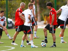 Germany's national team coach Joachim Low (third right) talks to player Toni Kroos (third left) during a training session in the village of Santo Andre north of Porto Seguro on Saturday, July 5, 2014. (Arnd Wiegmann/Reuters)