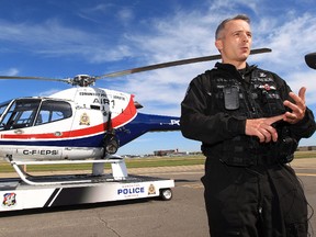 Edmonton Police Service Tactical Flight Officer Cst. Tom Bechthold, speaks to the media about the safety risks to officers when laser pointers are flashed at the police helicopter, at the City of Edmonton Airport, in Edmonton, Alta., Monday Sept. 9, 2013. David Bloom/Edmonton Sun/QMI Agency