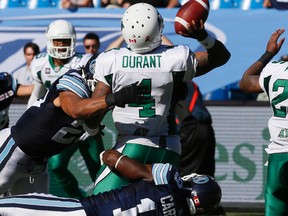 Jalil Carter and Shane Horton combine to haul down Riders quarterback Darian Durant in the backfield on Saturday, one of five sacks a revitalized Argonauts defence produced in their 48-15 romp at the Rogers Centre. (STAN BEHAL/TORONTO SUN)