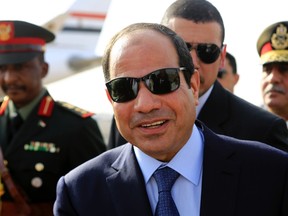 Egypt's President Abdel Fattah al-Sisi smiles upon arrival at Khartoum International Airport in Khartoum June 27, 2014. REUTERS/Mohamed Nureldin Abdallah