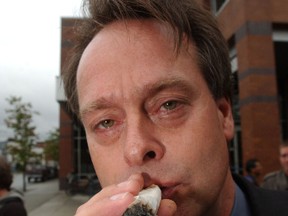 The "Prince of Pot" Marc Emery smokes a 15 gram joint during a protest in front of the police department September 18, 2003 in Vancouver, Canada.
FIle photo