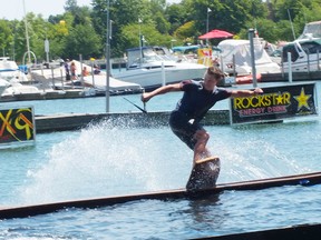 A wakeskater pulls off some moves during the Gridiron competition in Sarnia over the weekend. Top wakeskaters from around the world came for The Wakeskate Tour event. BRENT BOLES / THE OBSERVER / QMI AGENCY