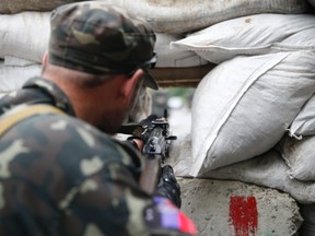 A pro-Russian fighter mans a checkpoint in the eastern Ukrainian city of Donetsk July 7, 2014. (REUTERS/Maxim Zmeyev)