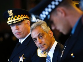 Mayor of Chicago Rahm Emanuel, centre, looks over at one of the Chicago Police Department's newest recruits prior to their graduation ceremony for in Chicago, Illinois, April 21, 2014. Emanuel is sitting next to Police Superintendent Garry McCarthy.  (REUTERS/Jim Young)