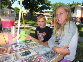 Ty, 7, and Olivia Colquhoun, 11, recently held a yard sale to raise money for the Sarnia and District Humane Society. The Sarnia siblings were inspired to help after hearing about Joe the cat, shot 17 times with a pellet gun, earlier this year. (BRENT BOLES, The Observer)
