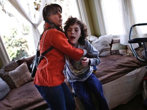 Missy Miller holds her son Oliver, right, who has epilepsy, in their home at Atlantic Beach, New York January 7, 2014. (REUTERS/Mike Segar)