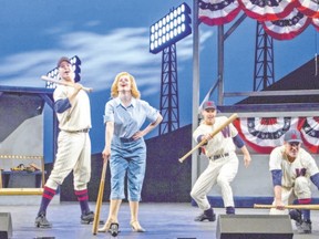 Heather McGuigan, as reporter Gloria Thorpe, and the ensemble of baseball players in Damn Yankees, on at Huron Country Playhouse until Saturday. (Photo by Darlene O?Rourke)