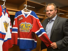 Steve Hamilton poses Monday with Oil Kings jerseys in the team's dressing room at Rexall Place. (Ian Kucerak, Edmonton Sun)