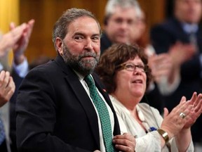 New Democratic Party leader Thomas Mulcair (C) receives a standing ovation from his caucus during Question Period in the House of Commons on Parliament Hill in Ottawa June 3, 2014. REUTERS/Chris Wattie