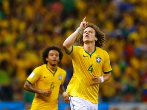 Brazil's David Luiz celebrates after scoring a goal during the World Cup quarterfinals against Colombia at the Castelao arena in Fortaleza, Brazil on Friday, July 4, 2014. (Marcelo Del Pozo/Reuters)