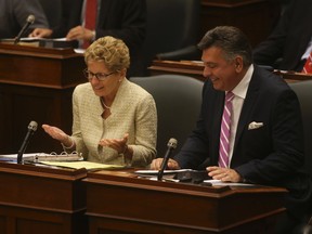 Ontario Premier Kathleen Wynne (L) with Finance Minister Charles Sousa. (JACK BOLAND/Toronto Sun)