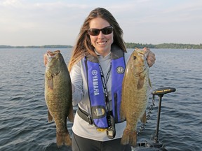 Ashley Rae with two smallmouth bass caught in the Rideau Lakes region. (Supplied photo)