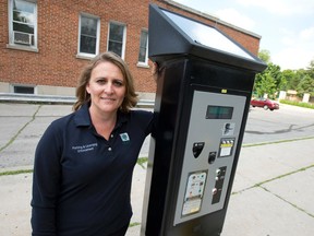 Annette Drost, manager of Municipal Law Enforcement Services in the City's Parking and Licensing Department and Compliance Services, stands next to a solar-powered parking meter on Clarence St. in London, Ontario on Monday July 7, 2014. (CRAIG GLOVER, The London Free Press)