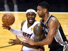 Tim Duncan (right) and the Spurs swept the LeBron James and Heat in the NBA Finals last month. Now James must decide if re-signing with Miami gives himself the best chance to dethrone San Antonio. (AFP)