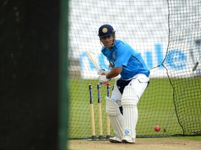 India's Mahendra Singh Dhoni batting in a net during a training session before Wednesday's first cricket test against England at Trent Bridge cricket ground in Nottingham, England, July 7, 2014. (PHILIP BROWN/Reuters)