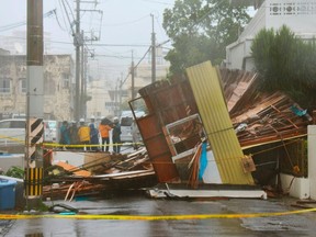 A wooden house which collapsed due to strong winds caused by Typhoon Neoguri is seen in Naha, on Japan's southern island of Okinawa, in this photo taken by Kyodo on July 8, 2014. (REUTERS/Kyodo)