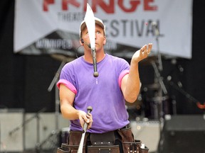 Chris Without the Hat juggles two knives and a Smarties candy at the Winnipeg Fringe Festival's outdoor stage at Old Market Square on Wed., July 18, 2012. JASON HALSTEAD/QMI Agency