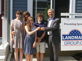 The Roth family accepts the keys to their brand new Habitat for Humanity home.