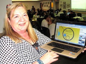 Kim Gaiswinkler, a core French teacher at St. Ursula Catholic School in Chatham, is one of several teachers with the St. Clair Catholic District School Board, who is volunteering to help create modules to help teachers effectively use technology in the classroom as part of the board's 21st Century Learning Project. She is pictured here, Tuesday, July 8, 2014, at the Catholic Education Centre in Wallaceburg, ON, where teachers are working on the modules this week. (ELLWOOD SHREVE, The Daily News)