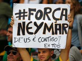 A fan holds up a poster reading, "#Strength Neymar, God is with you", before the 2014 World Cup quarter-finals between Costa Rica and the Netherlands at the Fonte Nova arena in Salvador July 5, 2014. (REUTERS/Sergio Moraes)