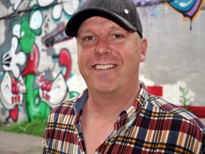 Local graffiti artist Brad Biederman near one of his public murals in downtown London Ont. July 8, 2014. Biederman’s most recent collection — smaller scale work in an exhibit called STORY.LINES. — will be on display at The ARTS Project from July 10 – July 19. CHRIS MONTANINI\LONDONER\QMI AGENCY