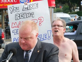 Shirtless protesters shouted down Mayor Rob Ford during the civic leader's stop on Eglinton Ave. on Tuesday. (MICHAEL PEAKE, Toronto Sun)